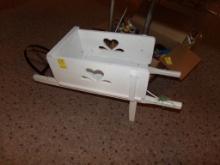 White Wooden Wheelbarrow Flower Planter Under the Table (Main Showrooom)