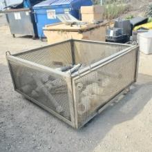 Large grated metal container with pvc pipe inside