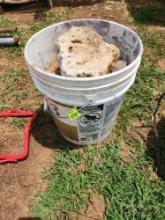 plastic bucket and assorted rocks