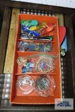Drawer of miscellaneous items, including tacks, paper clips, rubber bands