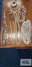 Pearl like costume jewelry necklaces, earrings, and bracelets