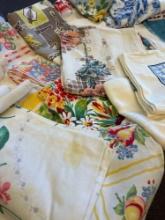 grouping of approximately 50 vintage printed table cloths