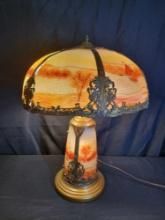 Antique reverse painted with ornate metal trim and lighted base