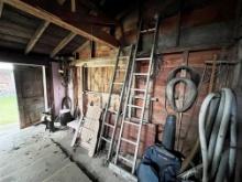 CONTENTS ALONG WALL: WOODEN FOLDING LOUNGE CHAIR, LADDERS, HORSE COLLARS, MISC.